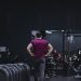 Man in a gym with fitness equipment, highlighting a healthy lifestyle.